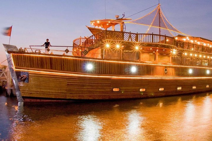 Set sail on a stunning Dubai Dhow Cruise Dinner where twinkling lights and picturesque views create a unique dining experience against the backdrop of the Marina skyline.